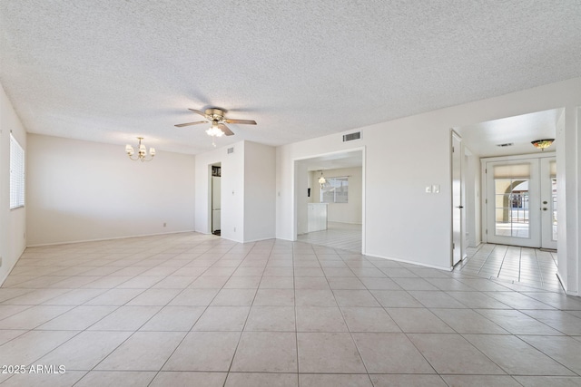 spare room with light tile patterned floors and a wealth of natural light