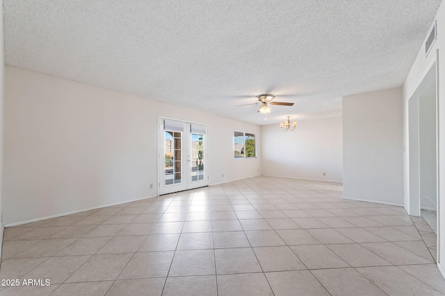 unfurnished room featuring light tile patterned floors, ceiling fan with notable chandelier, french doors, and a textured ceiling