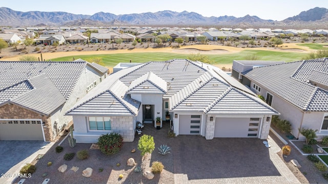 view of front facade featuring a garage and a mountain view