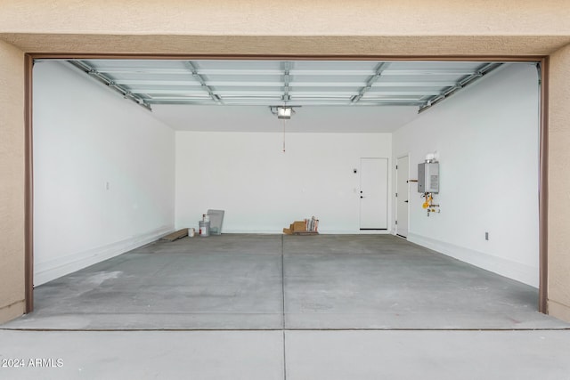 garage featuring tankless water heater and a garage door opener