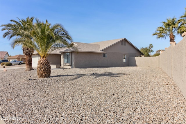 rear view of property with a garage