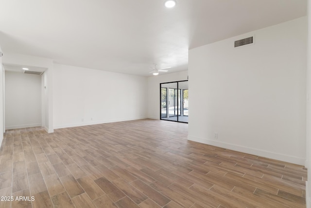 spare room featuring ceiling fan and light hardwood / wood-style flooring