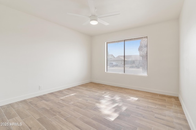 unfurnished room with ceiling fan and light wood-type flooring