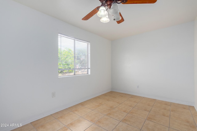 empty room featuring ceiling fan and light tile patterned floors