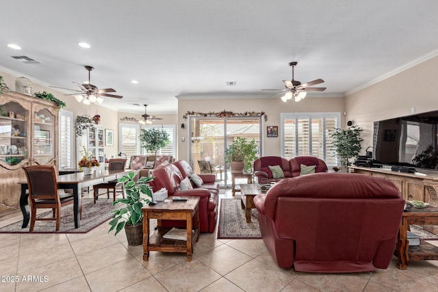 living room with light tile patterned floors, visible vents, and crown molding