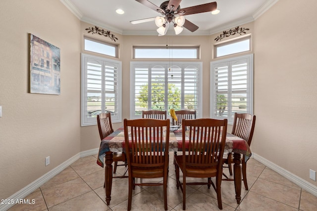 dining room featuring crown molding, baseboards, a wealth of natural light, and light tile patterned flooring