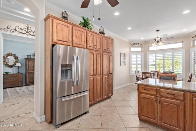 kitchen with ornamental molding, light tile patterned flooring, and stainless steel fridge with ice dispenser