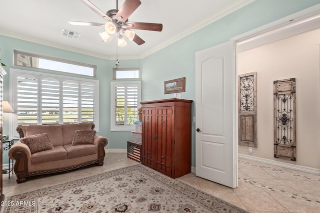 living area with baseboards, visible vents, ceiling fan, crown molding, and light tile patterned flooring