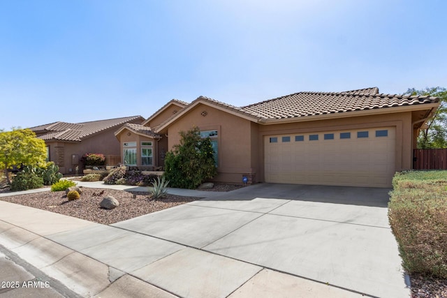 view of front of home with a garage, concrete driveway, a tiled roof, and stucco siding