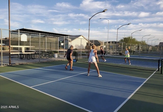 view of sport court featuring fence