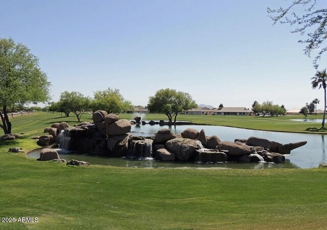 view of home's community featuring a yard and a water view