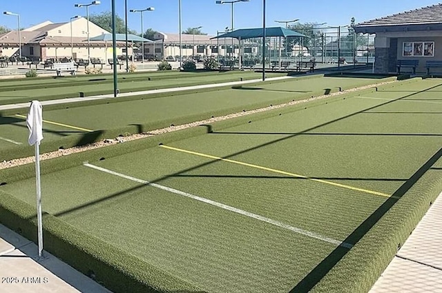 view of sport court with a residential view and fence