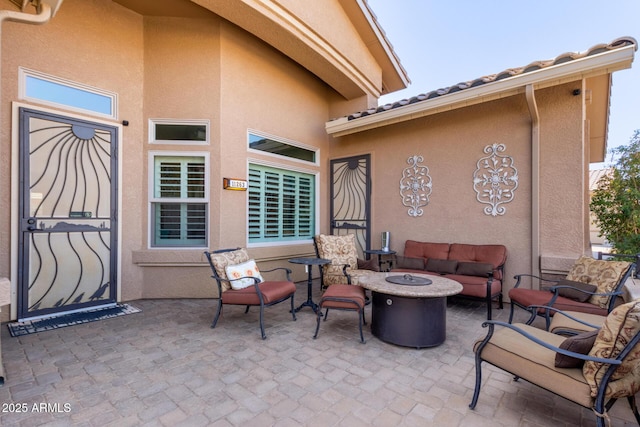 view of patio featuring an outdoor living space with a fire pit