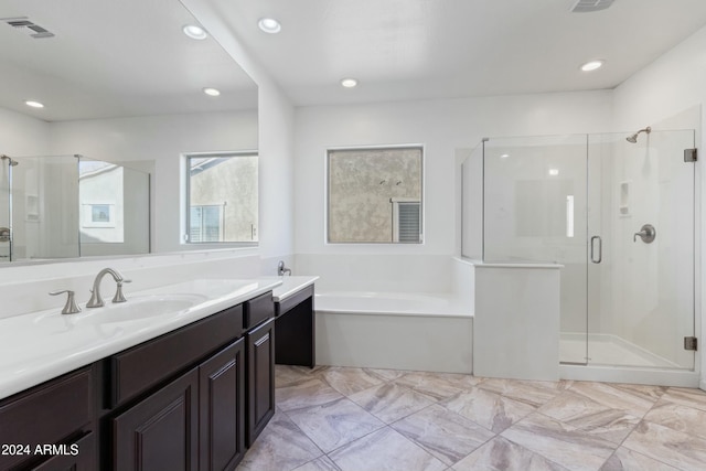 bathroom with vanity and plus walk in shower