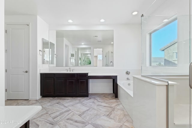 bathroom featuring a tub to relax in and vanity