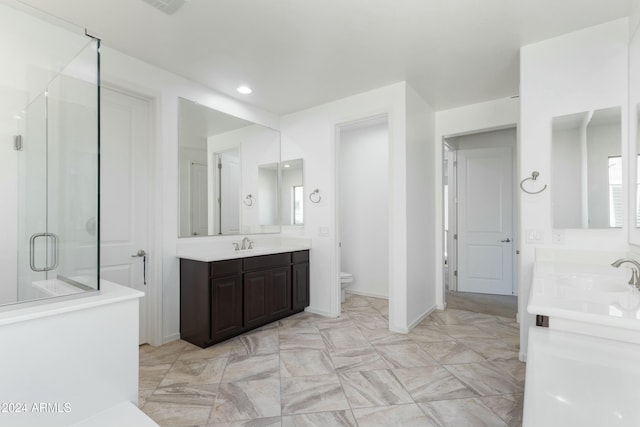 bathroom featuring walk in shower, vanity, and toilet