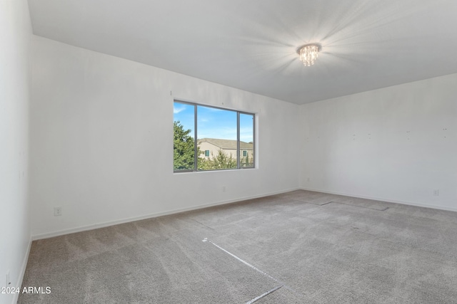 unfurnished room with light carpet