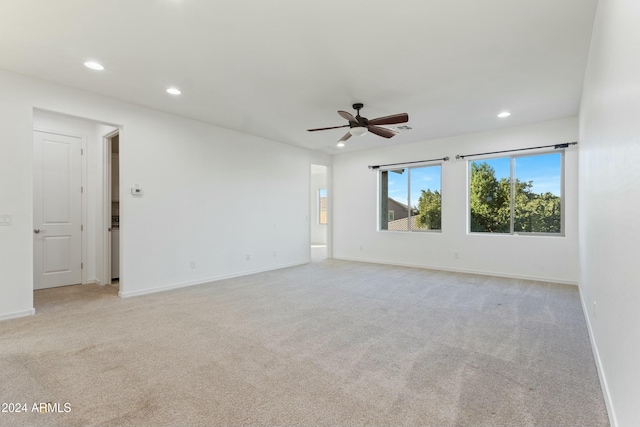 empty room with ceiling fan and light colored carpet