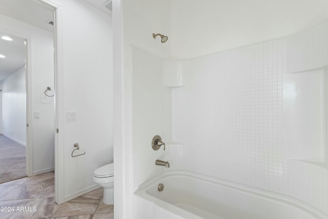 bathroom with tile patterned flooring, toilet, and shower / tub combination