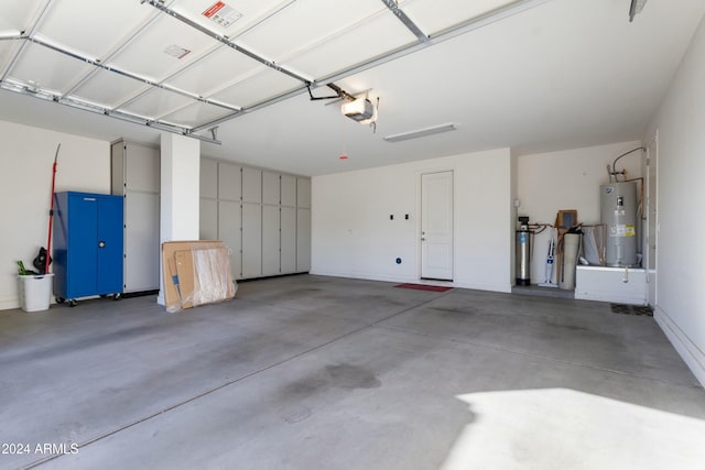 garage with electric water heater and a garage door opener