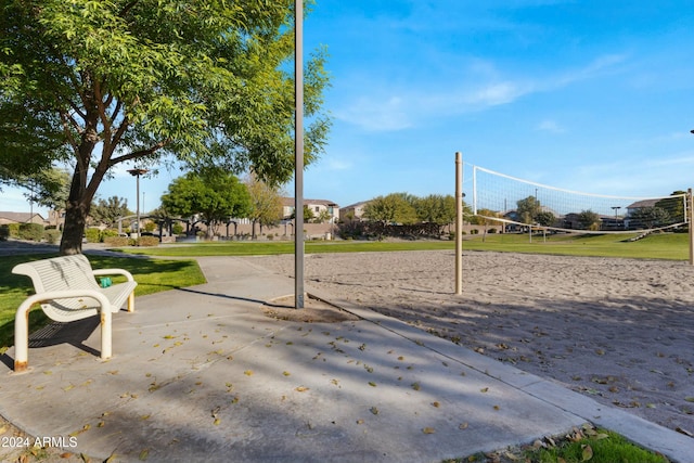 surrounding community with volleyball court and a lawn