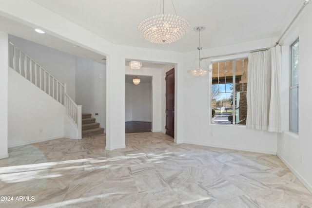 unfurnished dining area featuring an inviting chandelier