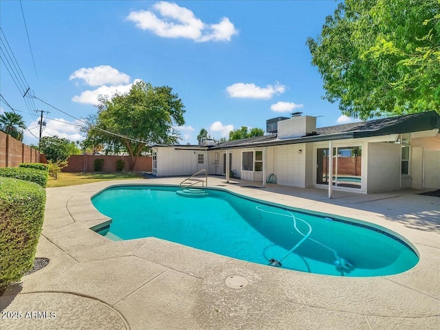 view of swimming pool featuring a patio, a fenced backyard, and a fenced in pool