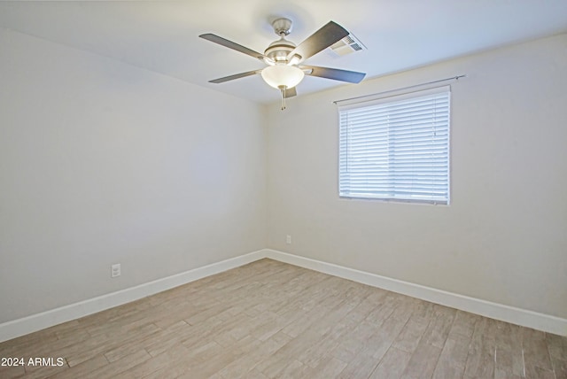 spare room featuring light hardwood / wood-style floors and ceiling fan