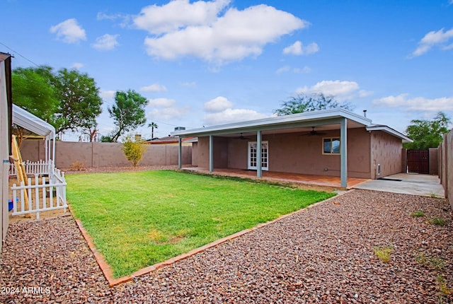 view of yard featuring a patio area and ceiling fan