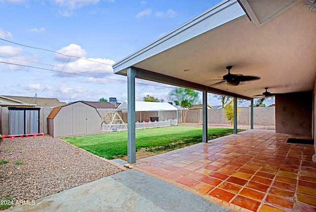 view of patio with ceiling fan and a storage unit