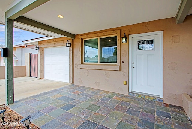 entrance to property with a patio area and a garage