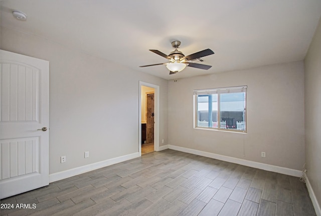 empty room with light wood-type flooring and ceiling fan