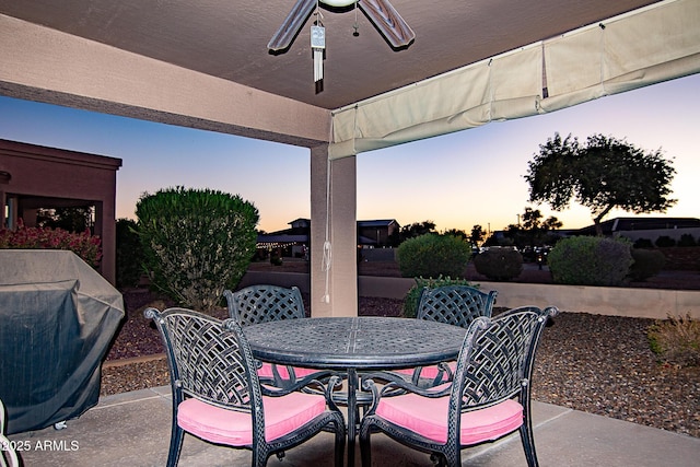 view of patio terrace at dusk