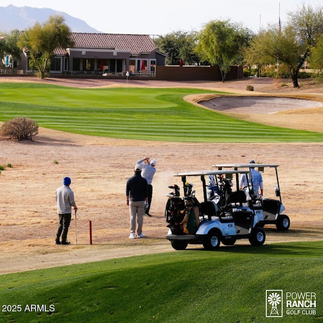 surrounding community featuring view of golf course and a yard