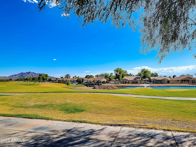 view of community with a yard, a residential view, and a mountain view