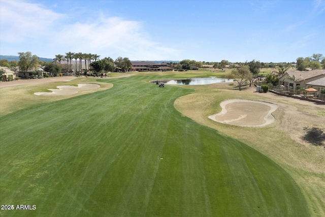 view of community with view of golf course and a water view