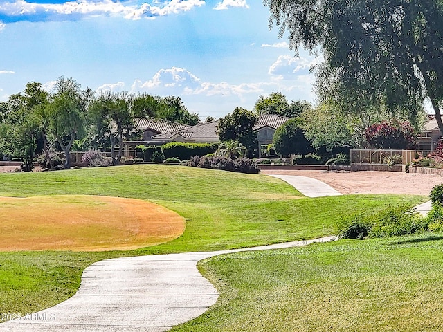 surrounding community featuring a lawn and golf course view