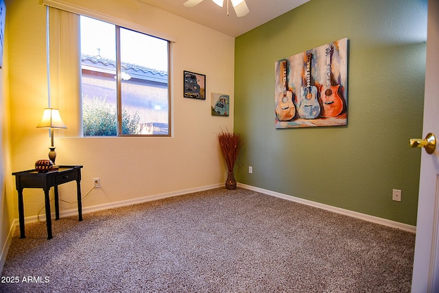 empty room with a ceiling fan, carpet, and baseboards