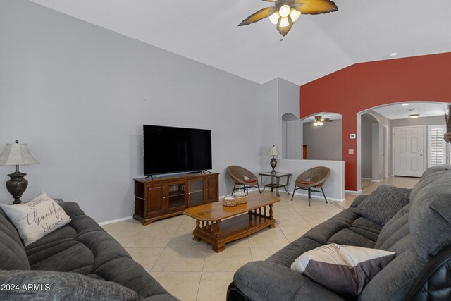 living room with vaulted ceiling, light tile patterned floors, and ceiling fan