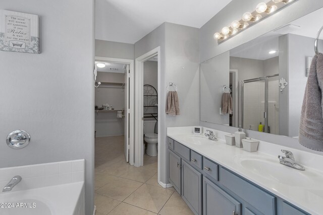 full bathroom with toilet, vanity, separate shower and tub, and tile patterned flooring