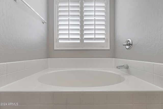 bathroom featuring tiled tub