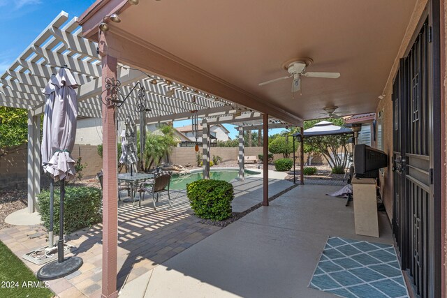 view of patio / terrace featuring ceiling fan, a fenced in pool, and a pergola