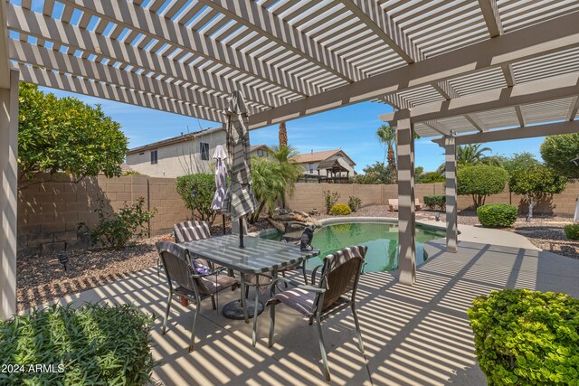 view of patio / terrace with a pergola and a fenced in pool