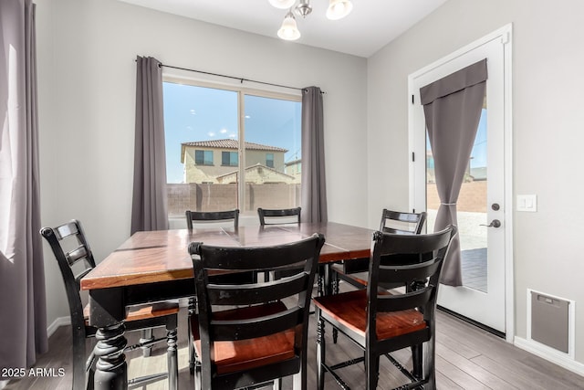 dining area featuring baseboards and light wood-type flooring