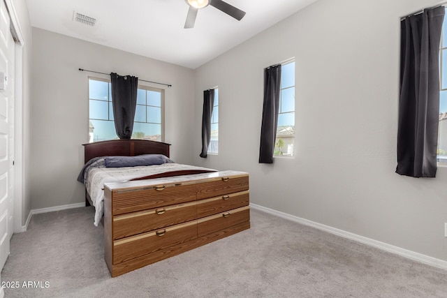 bedroom featuring ceiling fan, baseboards, visible vents, and light carpet