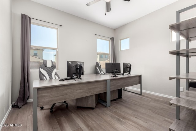 home office with ceiling fan, baseboards, and wood finished floors