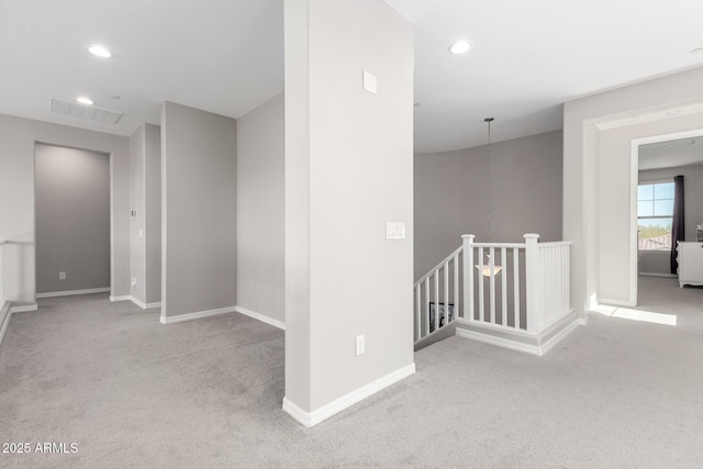 hallway featuring recessed lighting, an upstairs landing, baseboards, and carpet floors