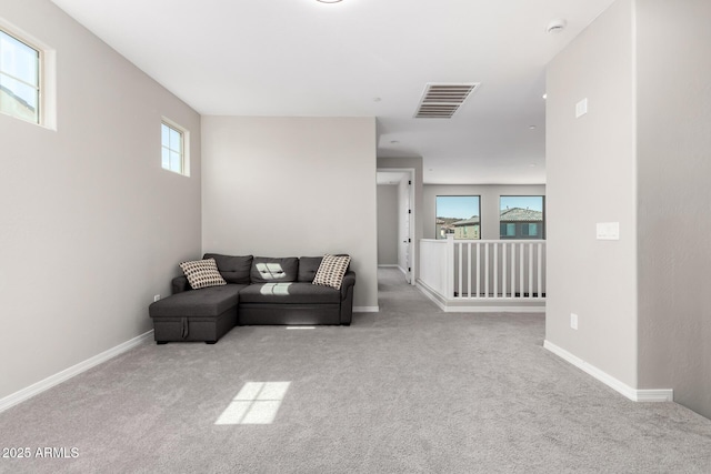 living room with visible vents, carpet floors, and baseboards