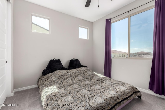 carpeted bedroom featuring ceiling fan and baseboards