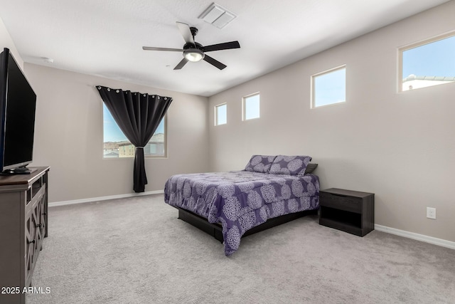 bedroom featuring visible vents, light colored carpet, a ceiling fan, and baseboards